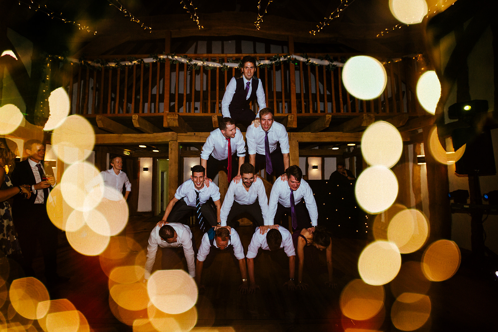 Fun human pyramid wedding photo