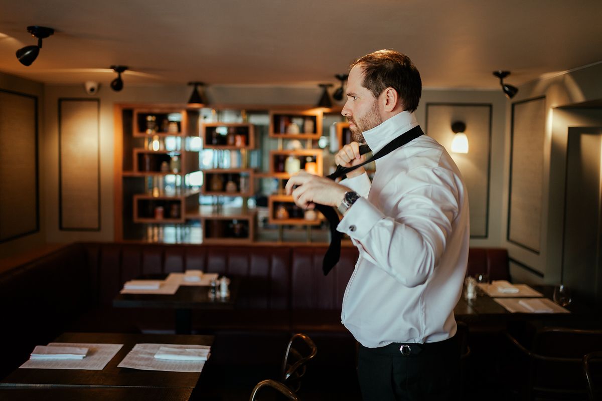 Groom getting ready at Cote Brasserie