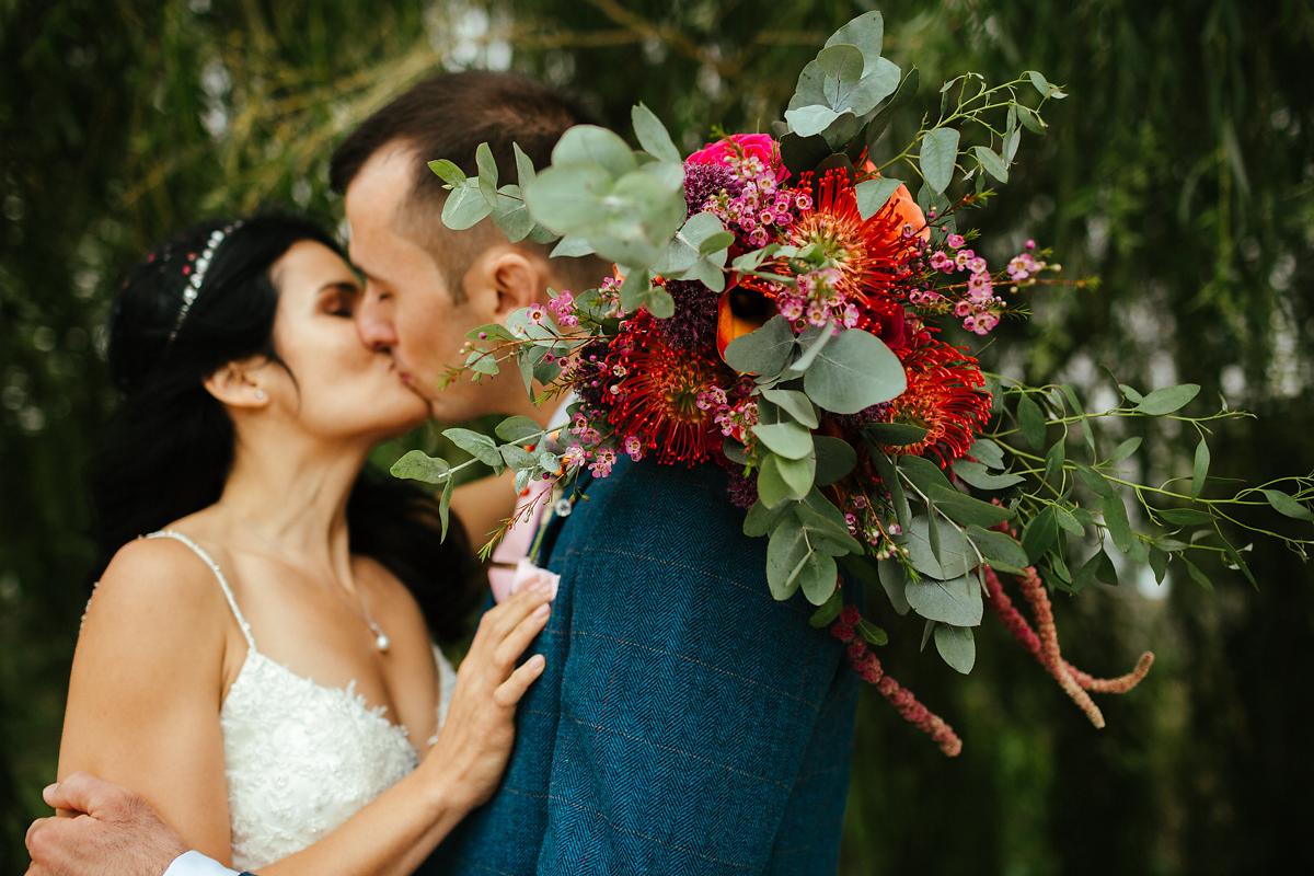 Strong red flowers and eucalyptus for a wedding bouquet